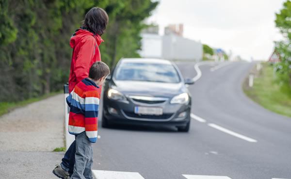 Mother and child using crosswalk